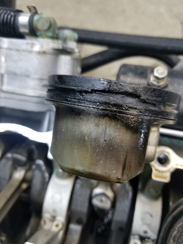 This piston had a complete melt down. This more than likely happened from a lean condition rather than detonation (Or a combination). Which probably took a scoop out of the cylinder as well.