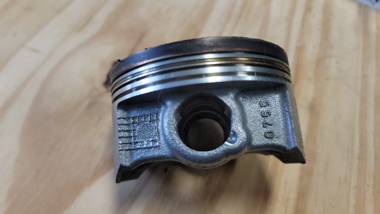 Old style piston that was more prone to failure. The ring lands was much weaker on this piston.